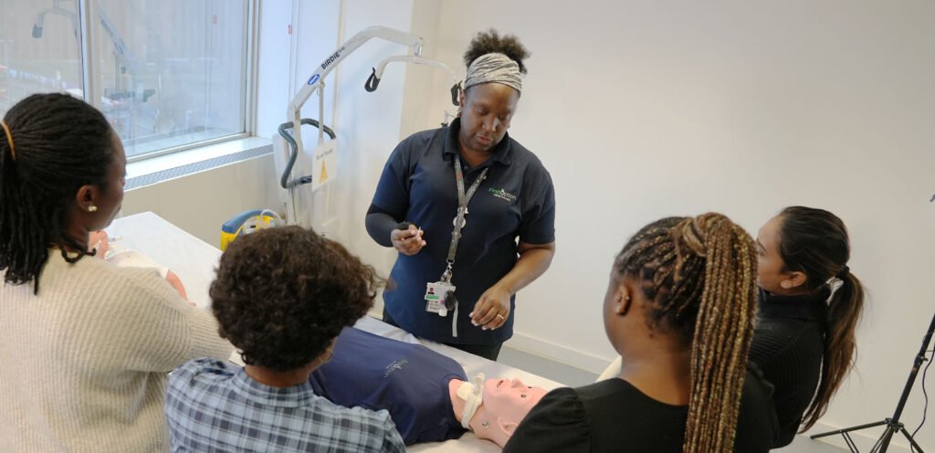 Staff member leading training session with other staff members