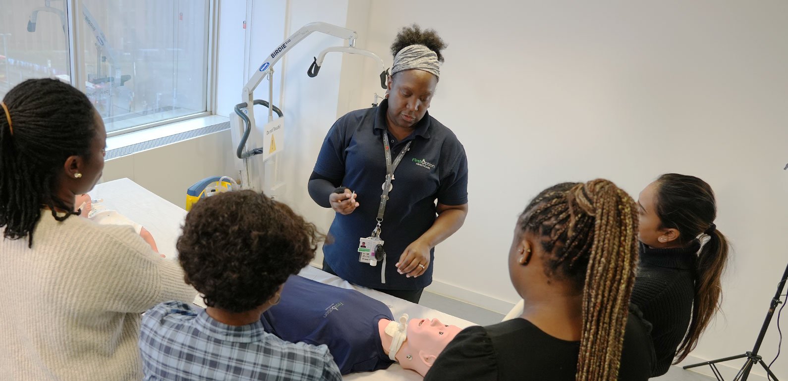 First Option staff member leading a training session with a group of trainees