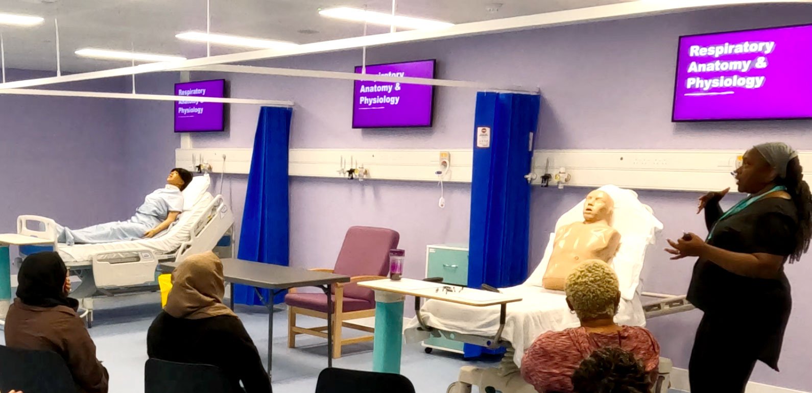 First Option staff member leading a training session on a training ward