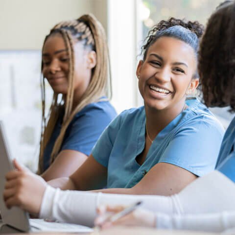 Smiling healthcare workers being training