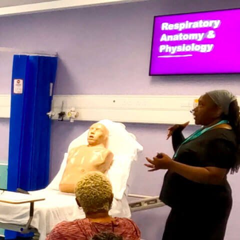 First Option staff member training others in First Option training facilities