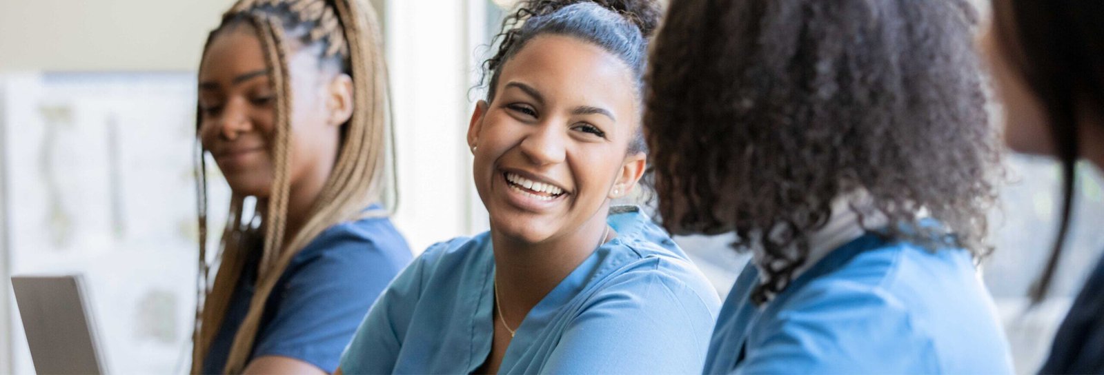 Group of health workers smiling while training